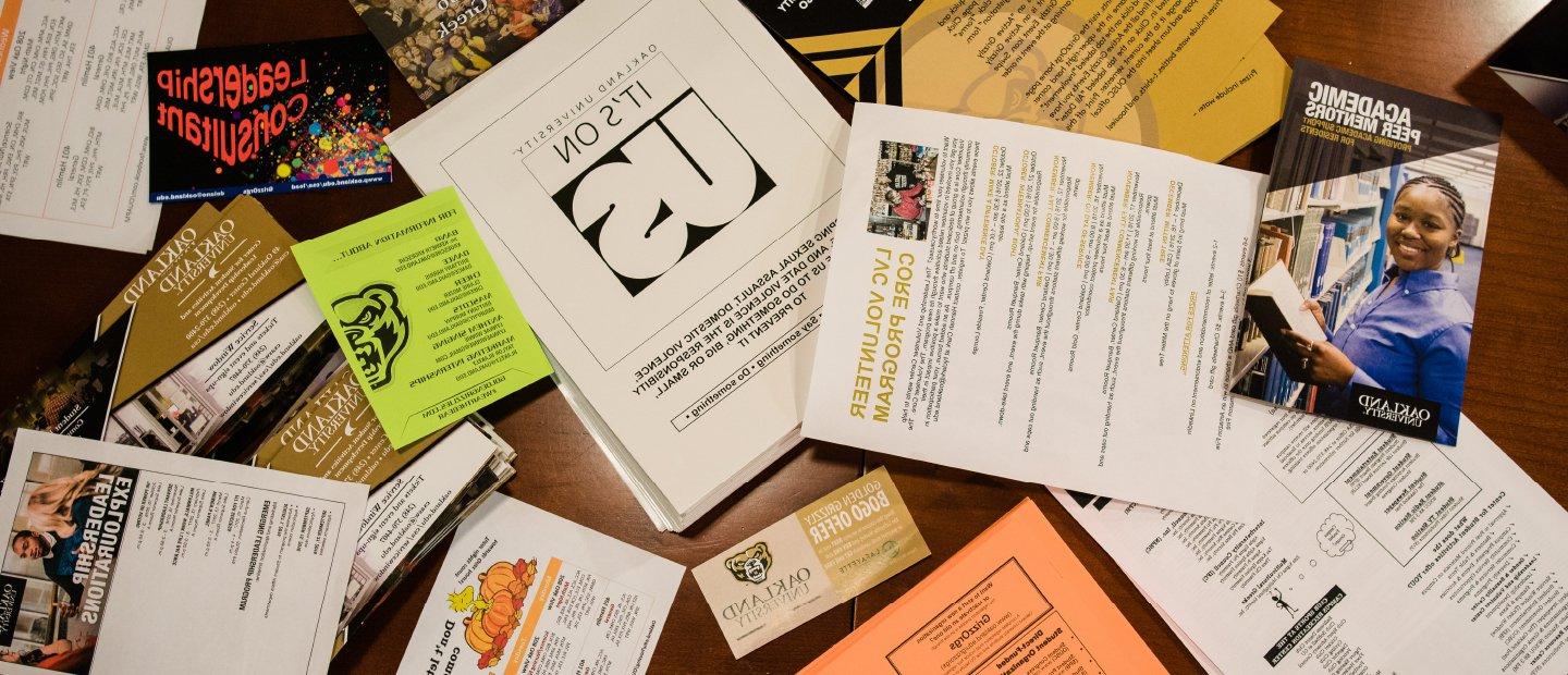 Table covered in a variety of forms and flyers
