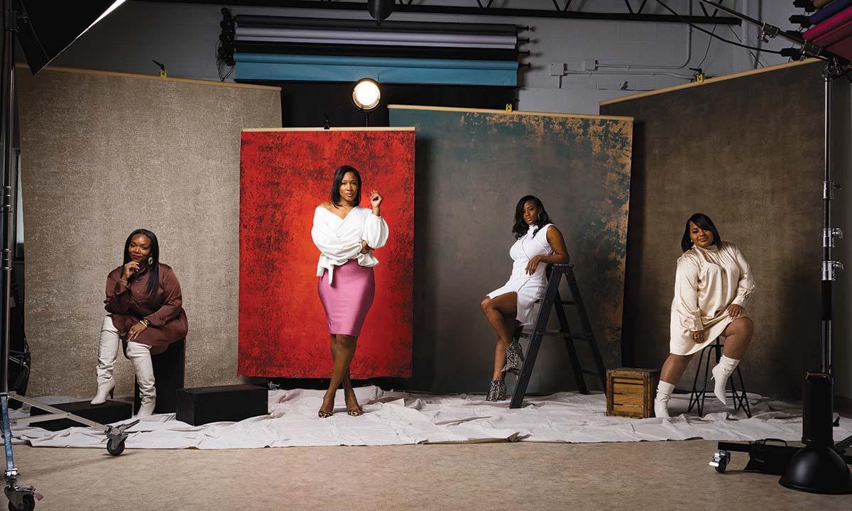 Four women in front of backdrops