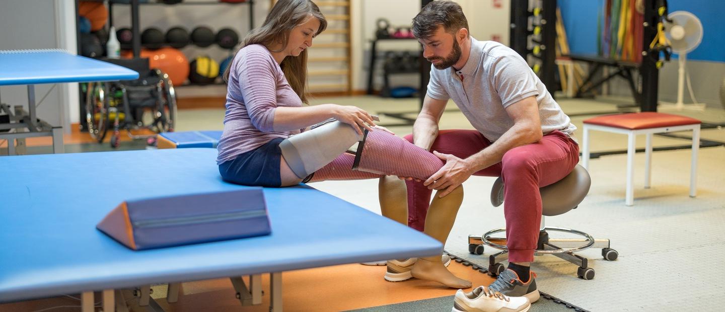 A man fitting a woman with a prosthetic leg