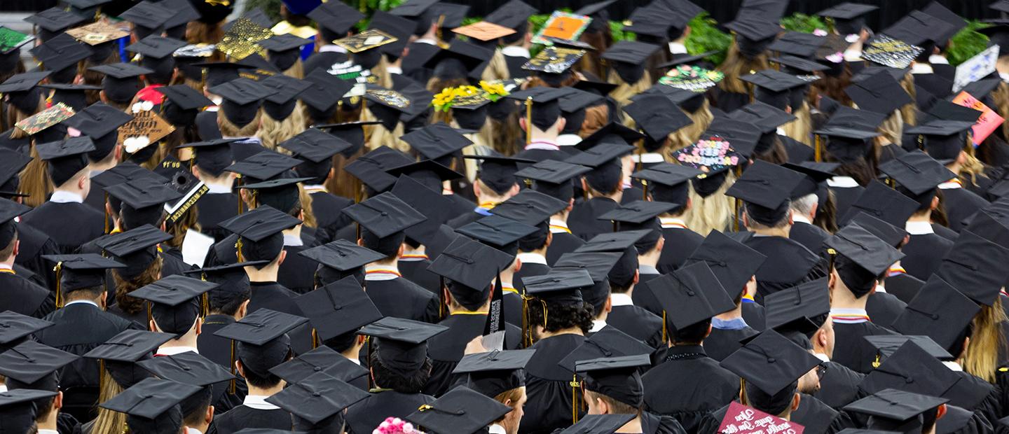 aerial photo of many graduates wearing black graduation caps